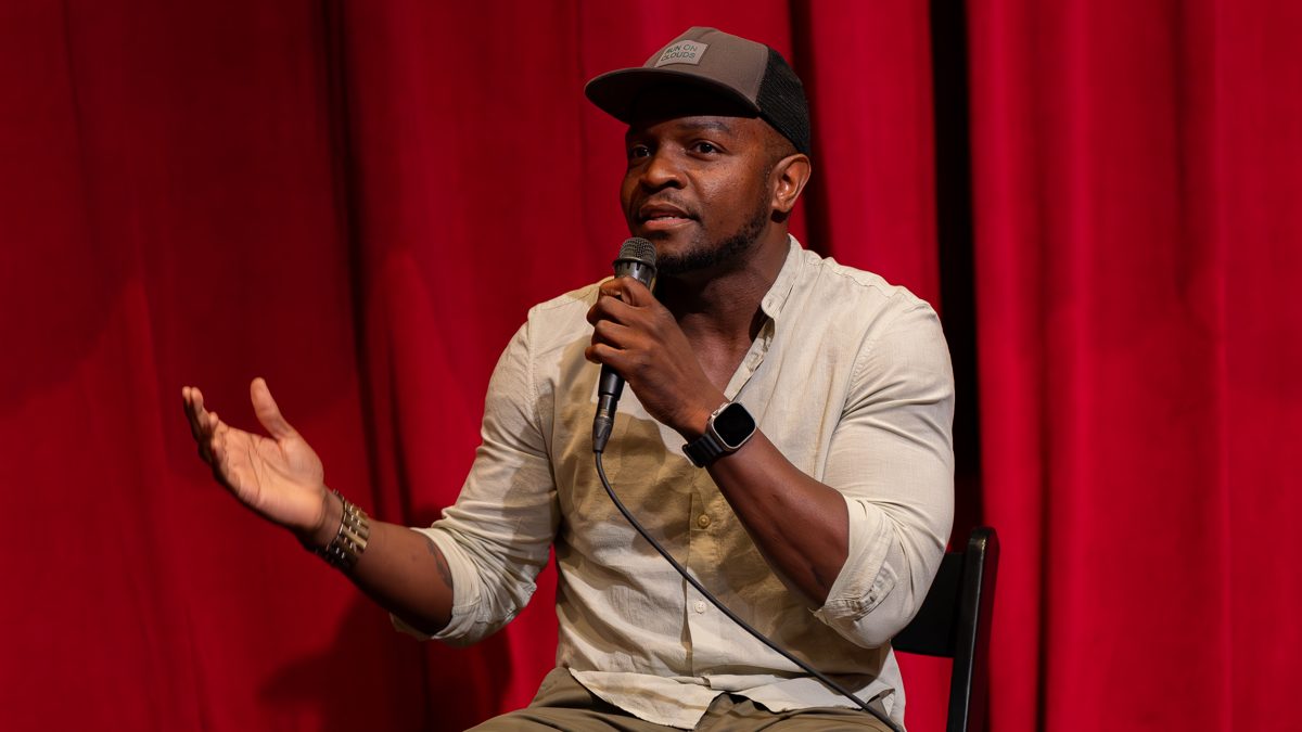 A speaker on stage addressing the audience after a screening