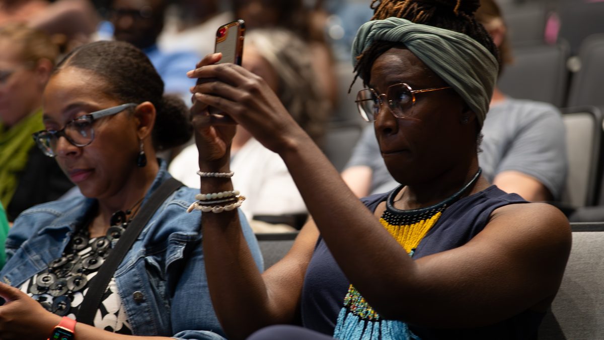 An audience member listening intently during a community conversation